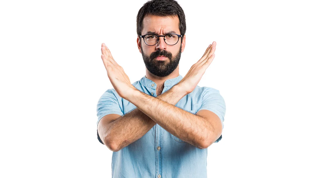 Man making a stop gesture representing mistakes to avoid when applying for a money loan