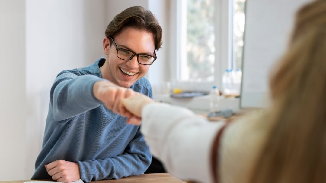 Une femme assise à un bureau avec une expression anxieuse, examinant des factures physiques et des charges imprévues tout en tenant sa tête, illustrant une crise financière résolue par un prêt garanti.
